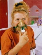 People with CF can use a device called a nebulizer to inhale medication that helps loosen mucus secretions in the lungs. Simon Fraser/RVI, Newcastle-upon-Tyne, Science Photo Library/Custom Medical Stock Photo.