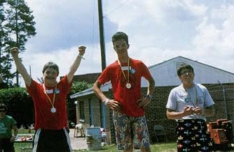 A trio of winners celebrate their victories at a Special Olympics meet in North Carolina. The Special Olympics were founded in 1968 to provide children and adults with mental retardation continuing opportunities to train and compete in athletic events. © B.E. Barnes/PhotoEdit.